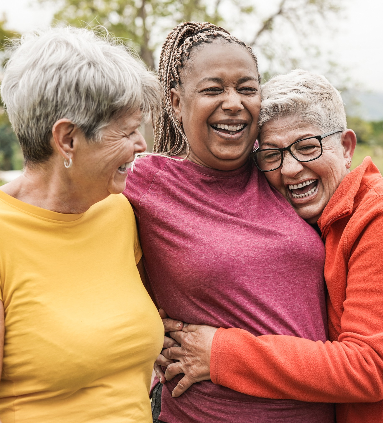 women hugging and smiling